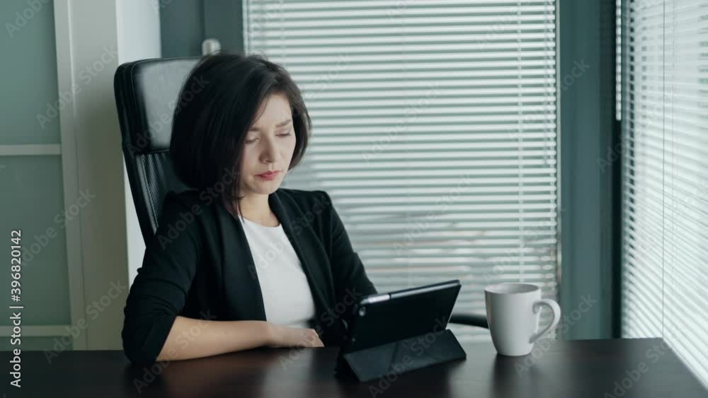 Woman having troubles with work or app crash. Young business lady sitting behind the desk with tablet, shaking head, being dissapointed and tired. Concept of freelance, startup, entrepreneur. Woman having troubles with work or app crash. Young business lady sitting behind the desk with tablet, shaking head, being dissapointed and tired. Concept of freelance, startup, entrepreneur.