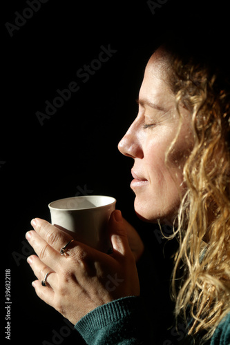 woman with a hot cup of coffee enjoying the moment