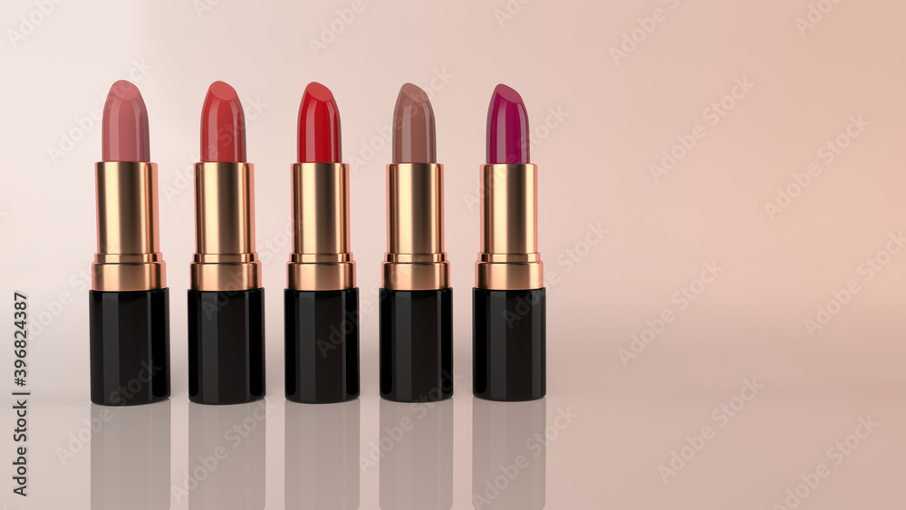 Obraz premium Set of colourful lipsticks in glossy gold and black containers. This is against a nice sunset shaded 