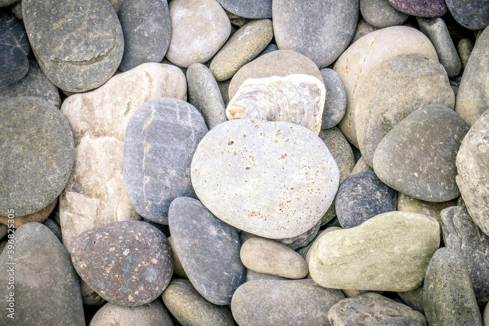 Smooth round large flat pebbles covering the whole image Smooth round large flat pebbles covering the whole image