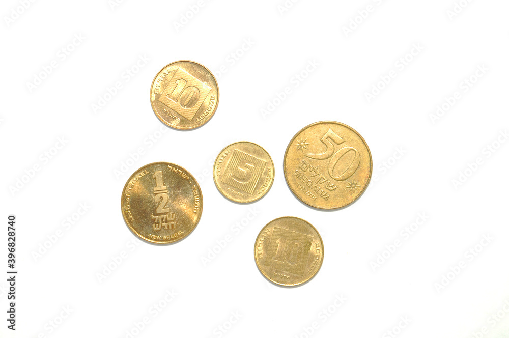 Israeli coins on white background close-up. Money, business, fortune Israeli coins on white background close-up. Money, business, fortune