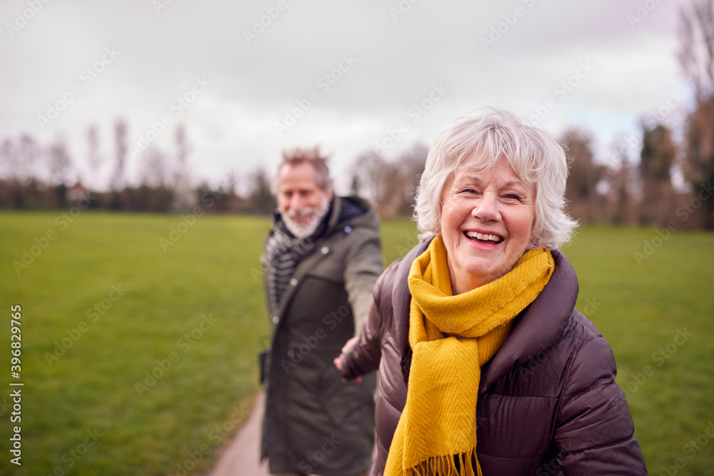 Portrait Of Loving Senior Couple Enjoying Autumn Or Winter Walk Through Park Together Portrait Of Loving Senior Couple Enjoying Autumn Or Winter Walk Through Park Together