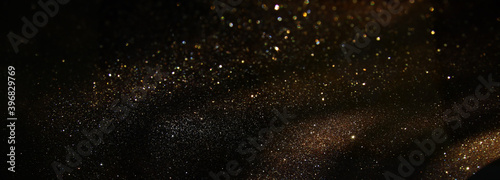 background of abstract gold and black glitter lights. defocused