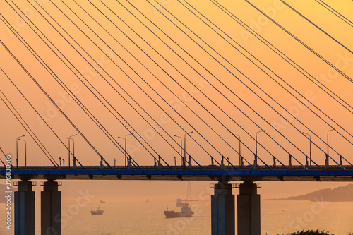 Fragment of the cable-stayed bridge - Russky Bridge to island Russkiy on the sunset. Vladivostok, Russia photo