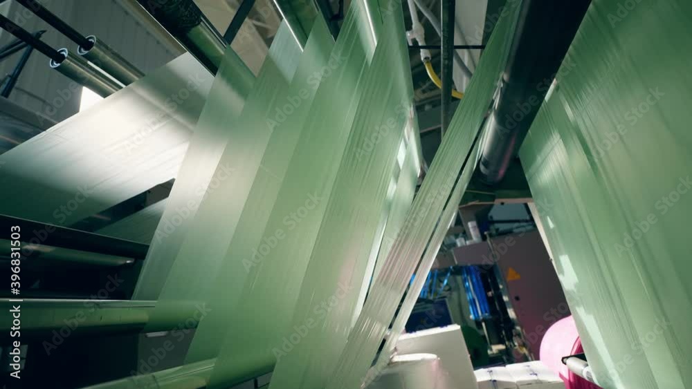 Rolling machine with sheets of polyethylene going through it