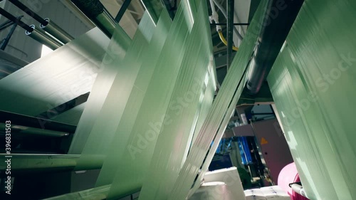 Rolling machine with sheets of polyethylene going through it