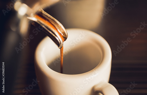 Close up of the espresso coming out the coffee machine into the cup