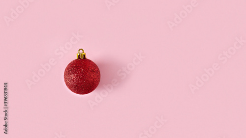 red christmas ball on pink background