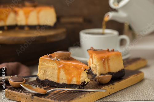 Cheesecake with salted caramel on brown  background. Copy space for text.