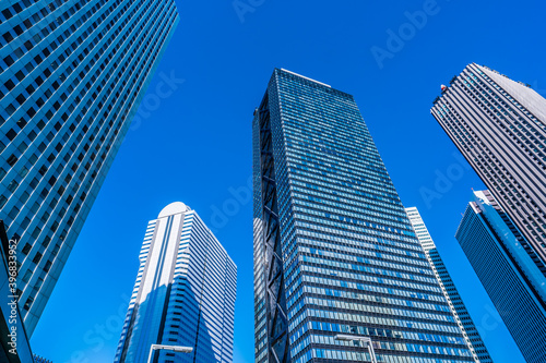 Asia, Real Estate, Corporate Construction and Business Concepts - Office Buildings and Blue Sky in Shinjuku, Tokyo, Japan