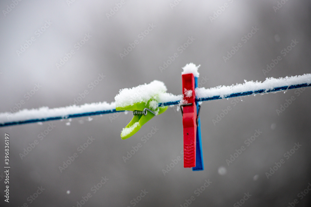 clothes peg on a clothesline in snowy winter day clothes peg on a clothesline in snowy winter day