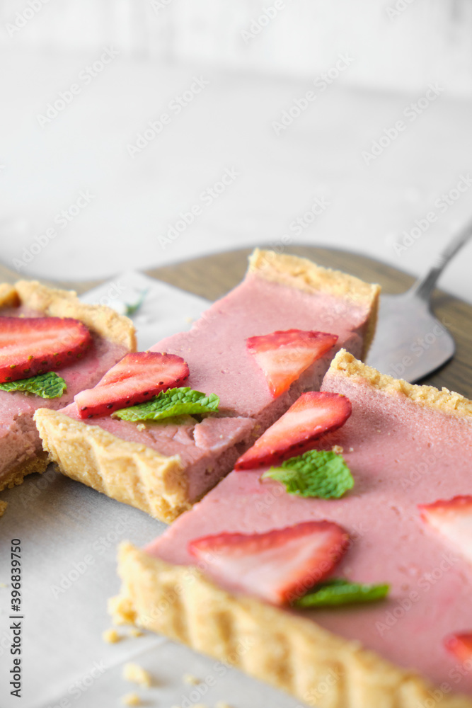 Strawberry Cheese tart on white cafe table background.