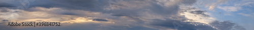Fluffy clouds in evening overcast sky panoramic view. Climate, environment and weather concept sky background. © wildman