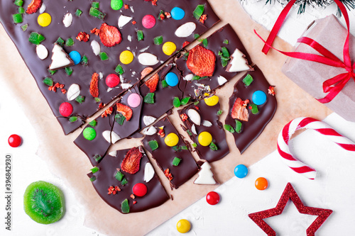 Chocolate bark with multicolored candies, freeze dried berries, almond and candied kiwi. Festive homemade dessert