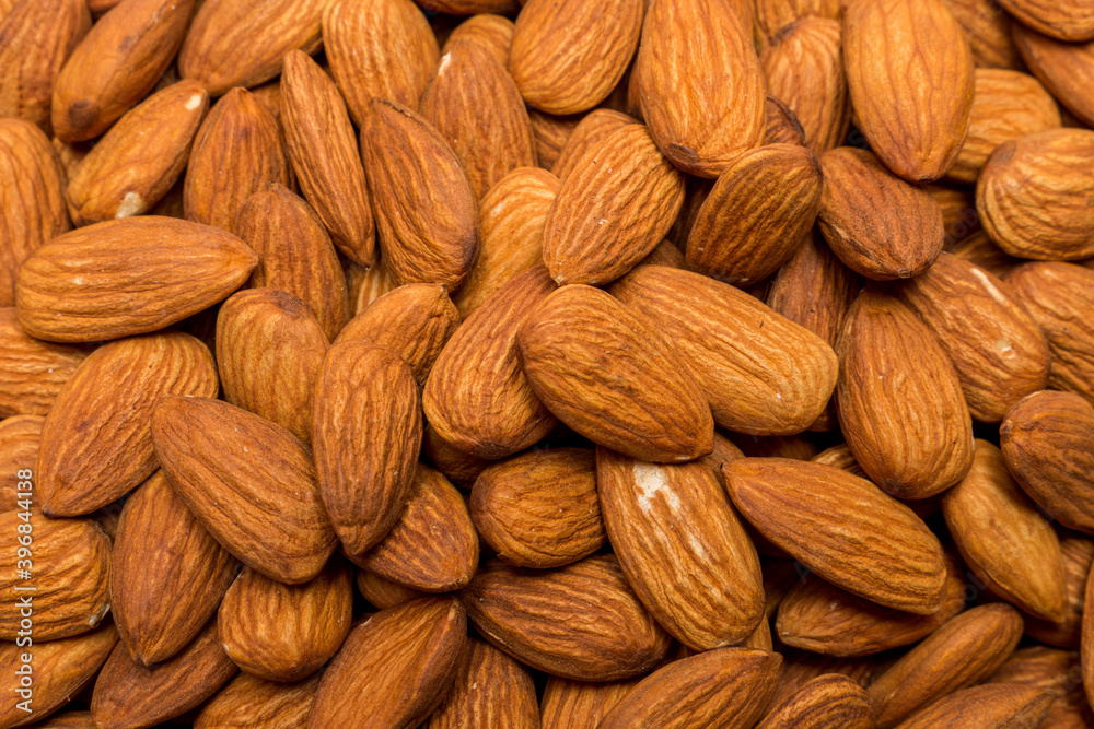 Fototapeta premium Whole almond nuts background. Vegetarian healthy snack. Organic food. Vegetable diet.