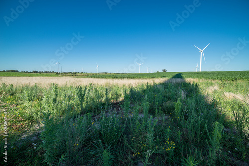 Shadow of a modern wind mill on the countyside near a wind mill farm photo