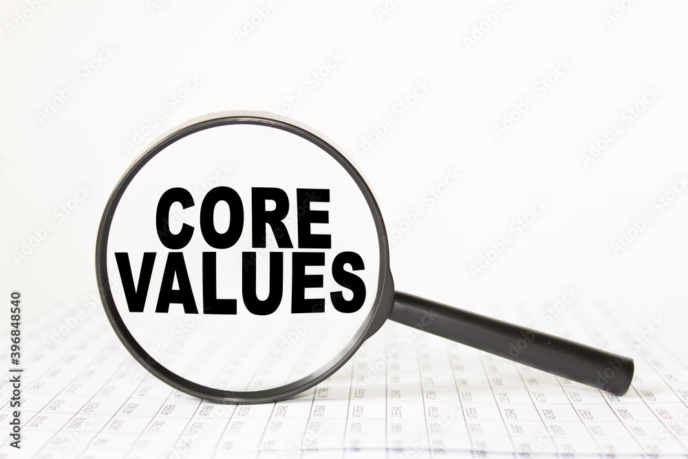 words CORE VALUES in a magnifying glass on a white background. business concept words CORE VALUES in a magnifying glass on a white background. business concept