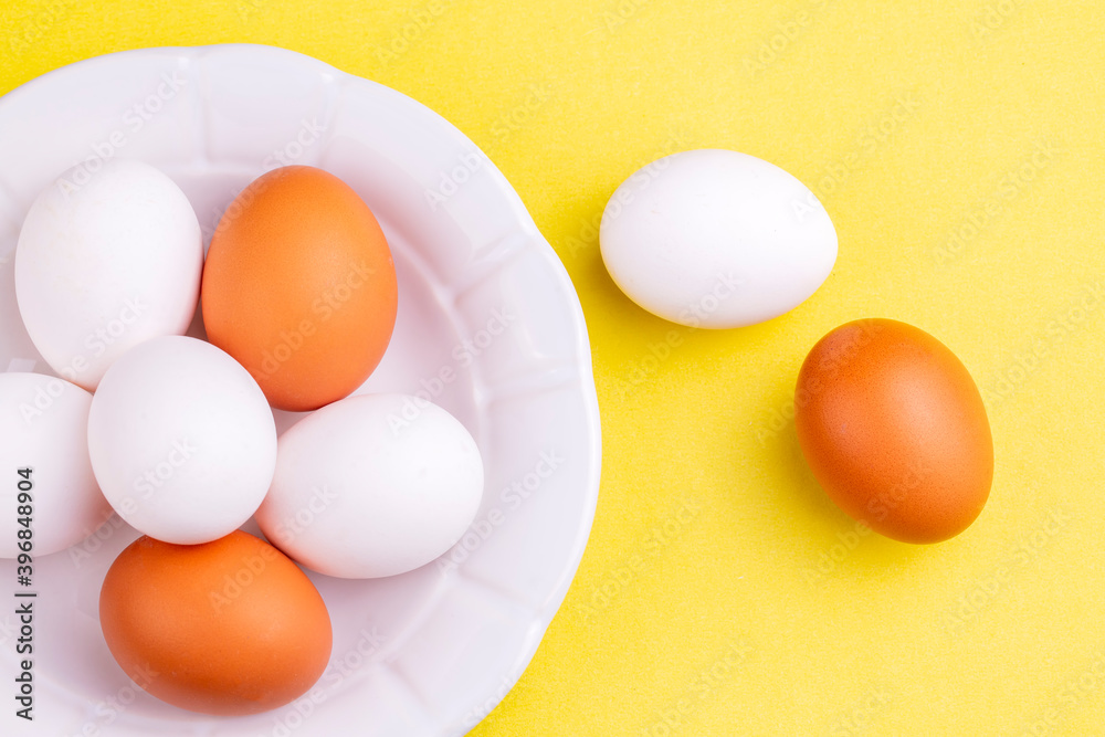 Eggs on yellow background, food concept photo
Eggs on yellow background, food concept photo