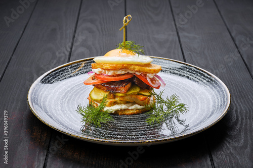 Photography Potato fritter burger with chicken breast, bacon, cucumber and tomato