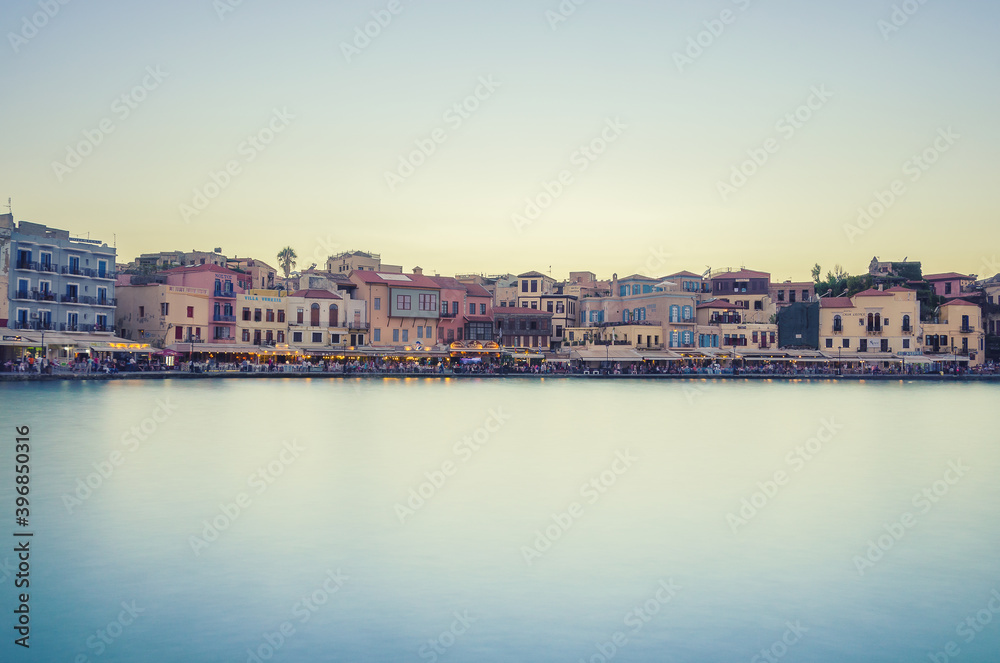Picturesque view of old harbour of Chania during sunset with silky sea. Crete, Greece.