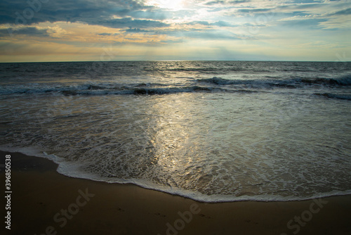 Beautiful seascape view with blue cloudy sky  Tropical beach with cloudy sky  Nature photography  Beach and Ocean Meet Under the cloudy Sky  Beautiful seascape view with sunset