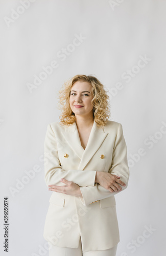 Portrait of a beautiful young woman in a white suit.