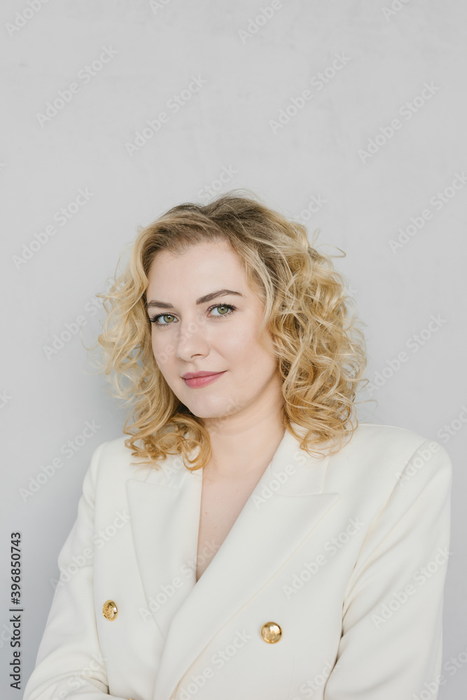 Portrait of a beautiful young woman in a white suit. Portrait of a beautiful young woman in a white suit.