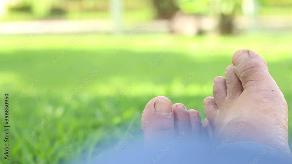 Relaxing time concept foot over green nature grass background. Relaxing time concept foot over green nature grass background.