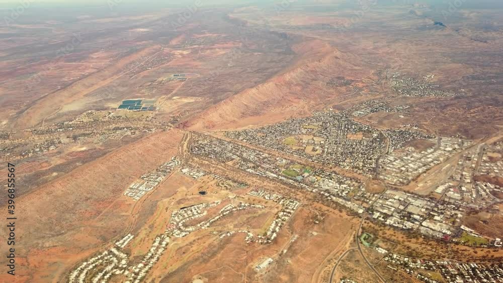 Aerial view of Alice Springs skyline in Australia. Scenic flight with main buildings of Alice Springs city downtown. Red Centre desert with Macdonnell ranges of Northern Territory in Central Australia Aerial view of Alice Springs skyline in Australia. Scenic flight with main buildings of Alice Springs city downtown. Red Centre desert with Macdonnell ranges of Northern Territory in Central Australia