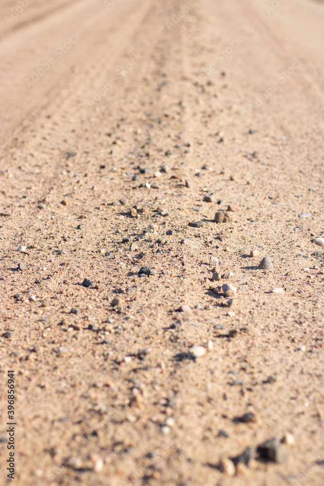 Sand. Sand close up. Stones of different different sizes on brown sand