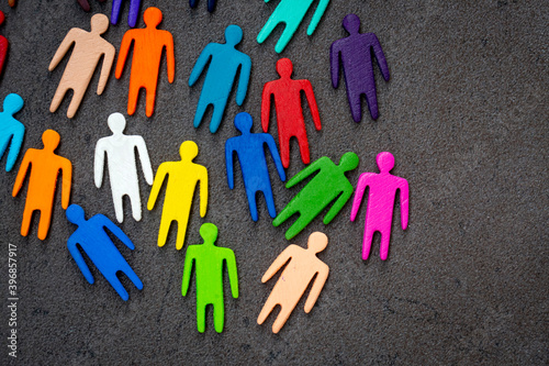 Equality and diversity concept. Multi-colored wooden figurines on a blackboard.