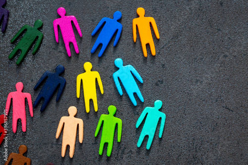Equality and diversity concept. Multi-colored wooden figurines on a blackboard. photo