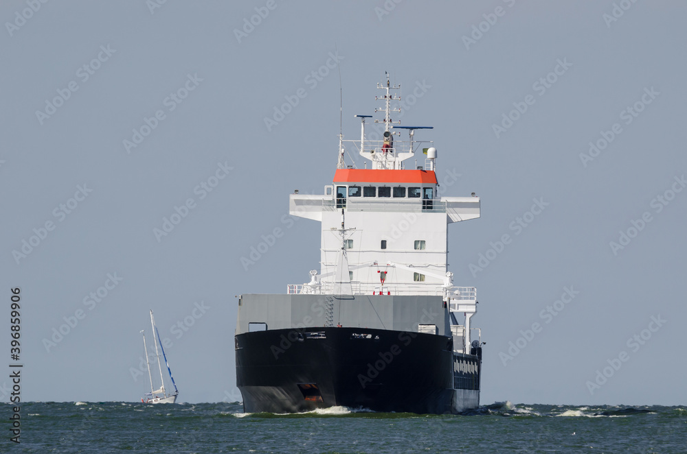 MERCHANT VESSEL - Freighter is sailing on the waterway MERCHANT VESSEL - Freighter is sailing on the waterway