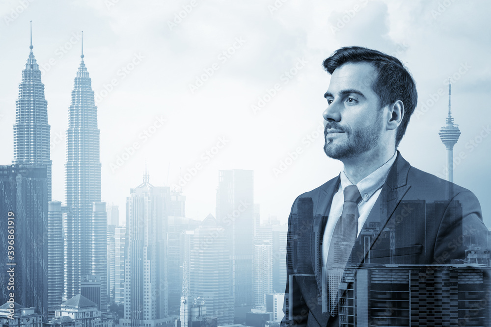 Young handsome businessman in suit thinking how to succeed, new career opportunities, MBA. Kuala Lumpur on background. Double exposure. Young handsome businessman in suit thinking how to succeed, new career opportunities, MBA. Kuala Lumpur on background. Double exposure.