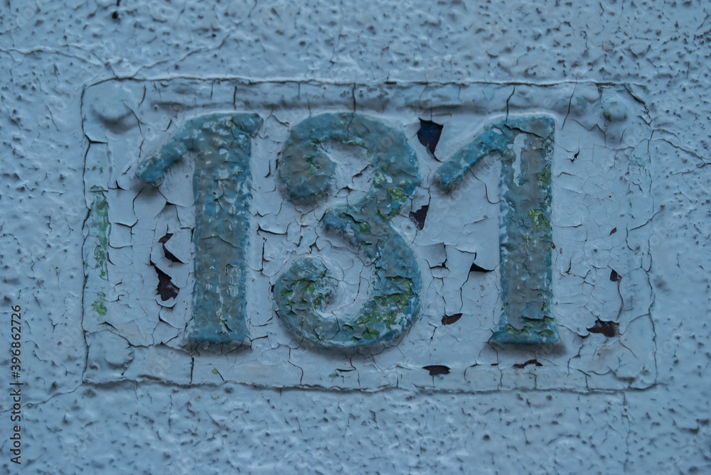 Old retro weathered cast iron plate with number 131 closeup Old retro weathered cast iron plate with number 131 closeup