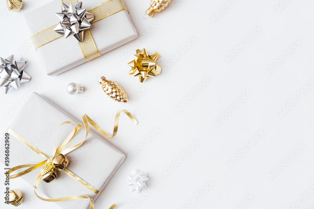 Christmas presents and gifts and gold and silver decorations on white background. Merry christmas, New Year holiday concept. Flat lay, top view, copy space. Christmas presents and gifts and gold and silver decorations on white background. Merry christmas, New Year holiday concept. Flat lay, top view, copy space.