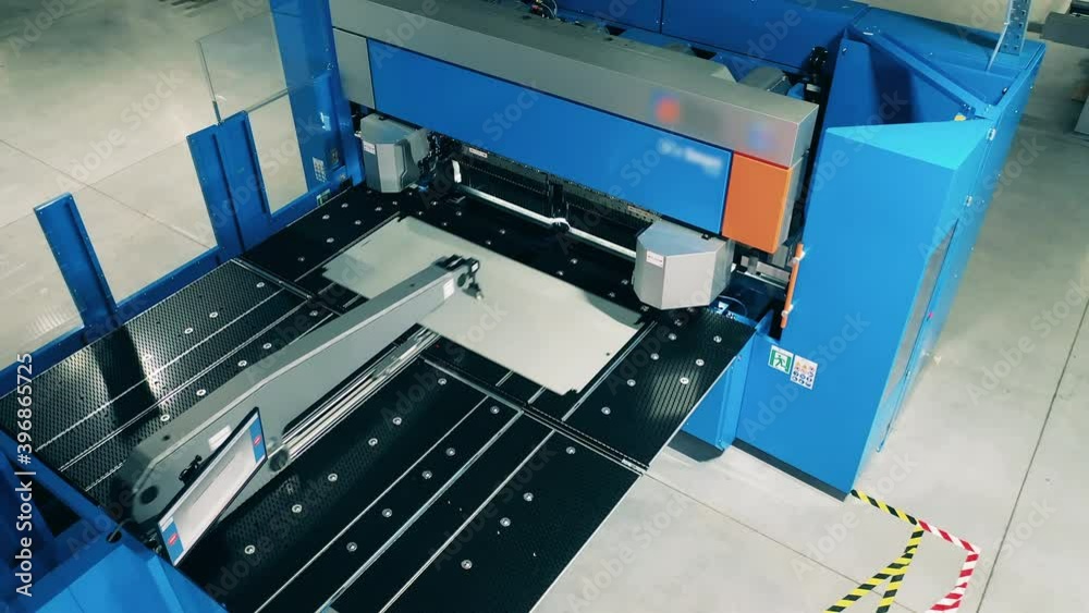 Automated factory machine is bending an aluminum plate Automated factory machine is bending an aluminum plate