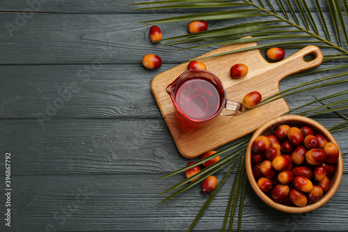 Fototapeta Naklejka Na Ścianę i Meble -  Flat lay composition with palm oil and fresh fruits on grey wooden table. Space for text
