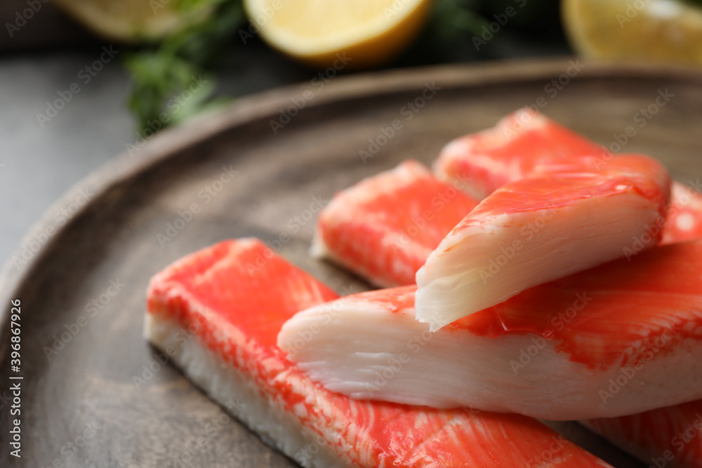 Delicious crab sticks on wooden board, closeup Delicious crab sticks on wooden board, closeup