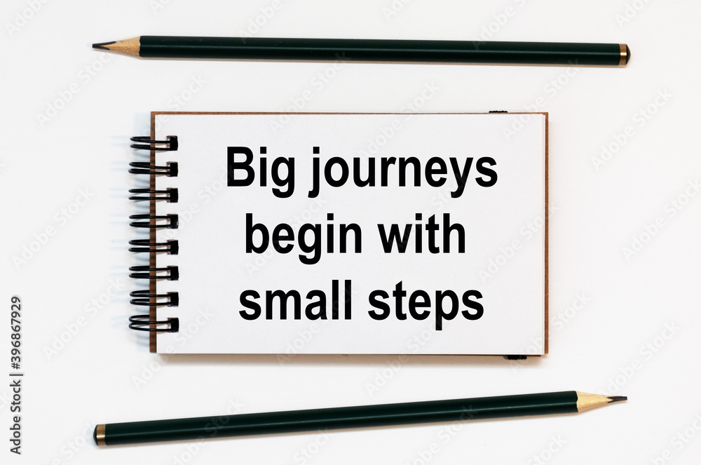 WHITE SPIRAL NOTEBOOK, TWO PENCILS WITH TEXT Big journeys begin with small steps WHITE SPIRAL NOTEBOOK, TWO PENCILS WITH TEXT Big journeys begin with small steps
