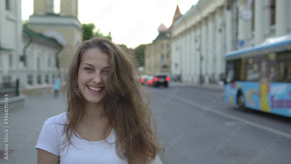 Beautiful girl with a smile on the background of the city Beautiful girl with a smile on the background of the city