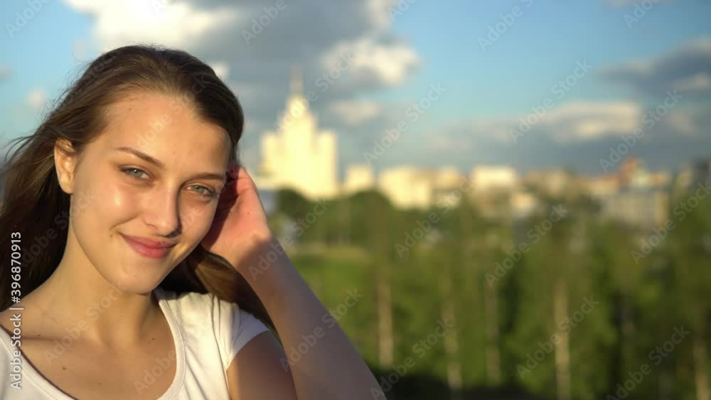 Beautiful girl with a smile on the background of the city Beautiful girl with a smile on the background of the city