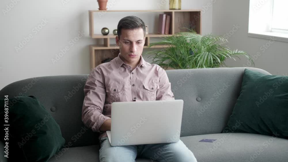 Young man shopping online at home Young man shopping online at home