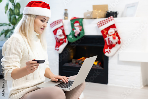 young woman making Christmas shopping on internet
