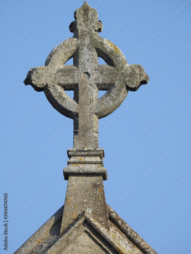 Stone cross on the roof of the church