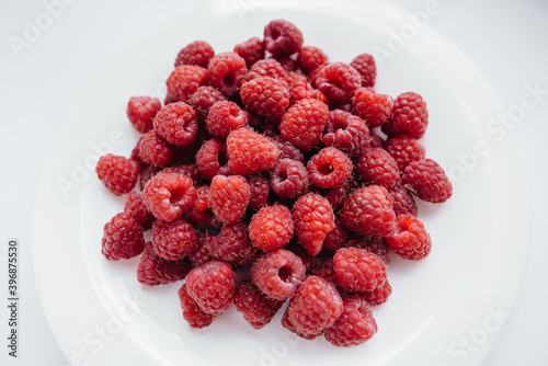Red raspberry berries close-up on a white background. Healthy food, natural vitamins. Fresh berries