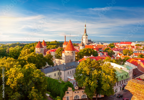 Scenic Tallinn summer cityscape with Saint Olav's church and old town walls and towers at sunset, Estonia photo
