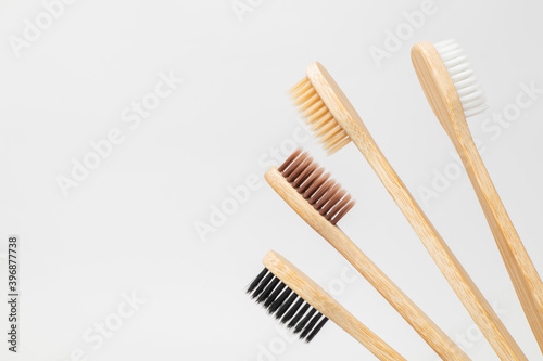 White, beige, brown and black bamboo toothbrushes. Zero waste, eco-friendly. Family set. © Snizhana