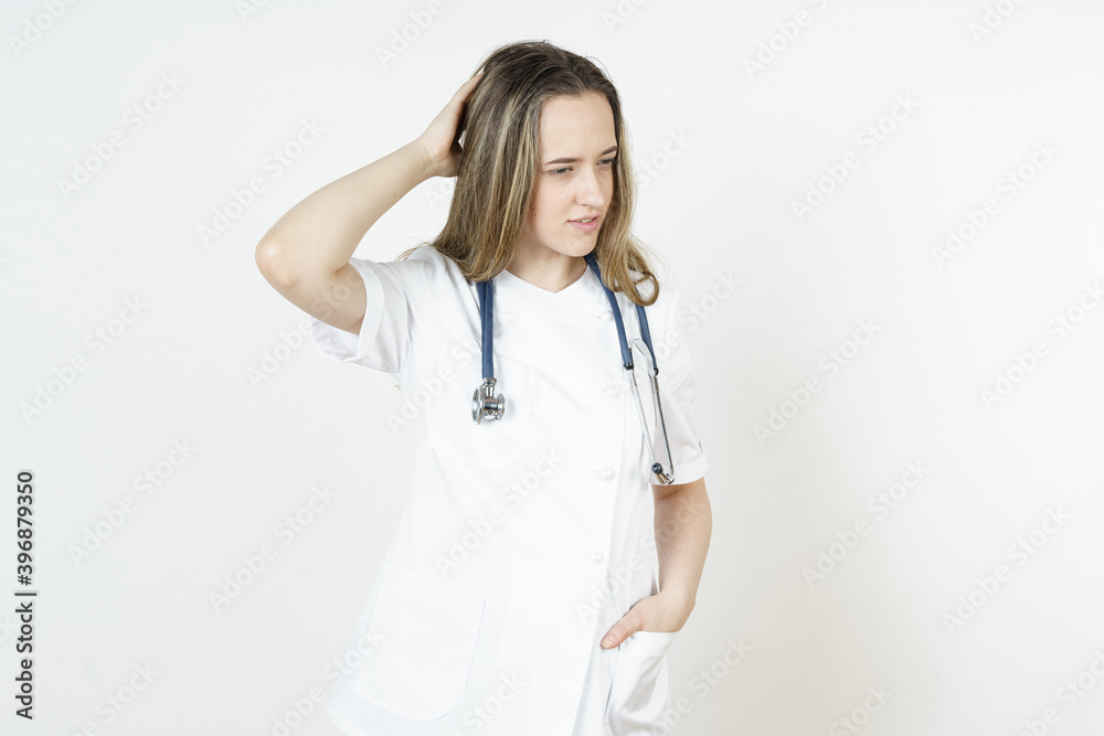Medicine and health concept. Doctor woman holds her head with her hand. Isolated on white background. Medicine and health concept. Doctor woman holds her head with her hand. Isolated on white background.
