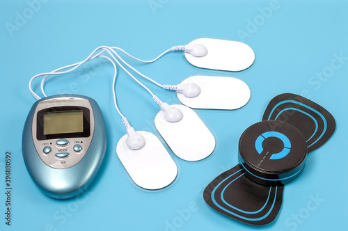 Equipment for electromassage on a blue background photo